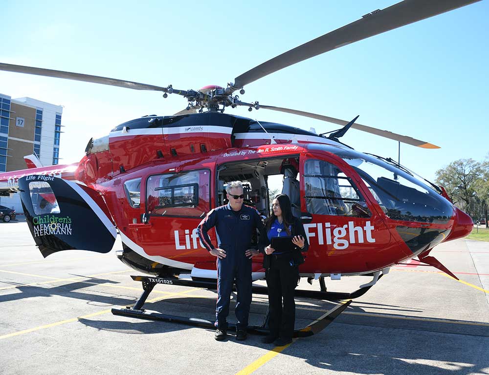 Emergency Medical Services students in front of helicopter