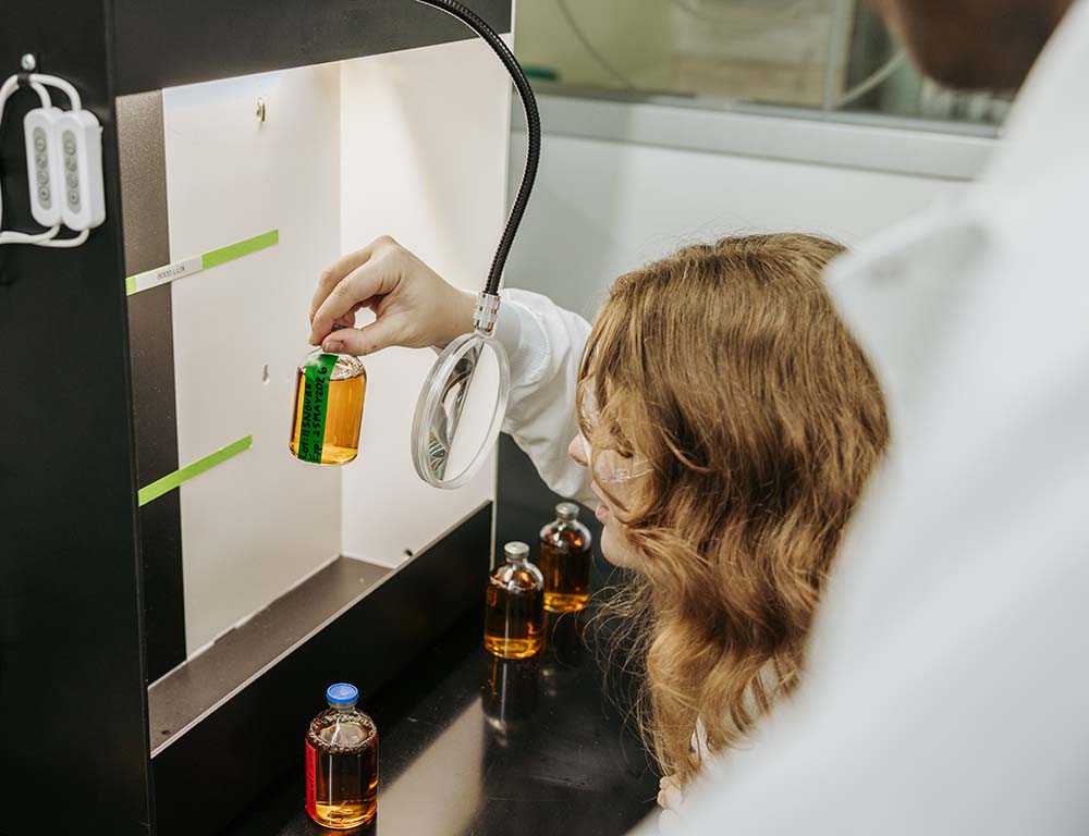 A student performs hands-on quality control procedures during a BioPath @ TMC learning experience.