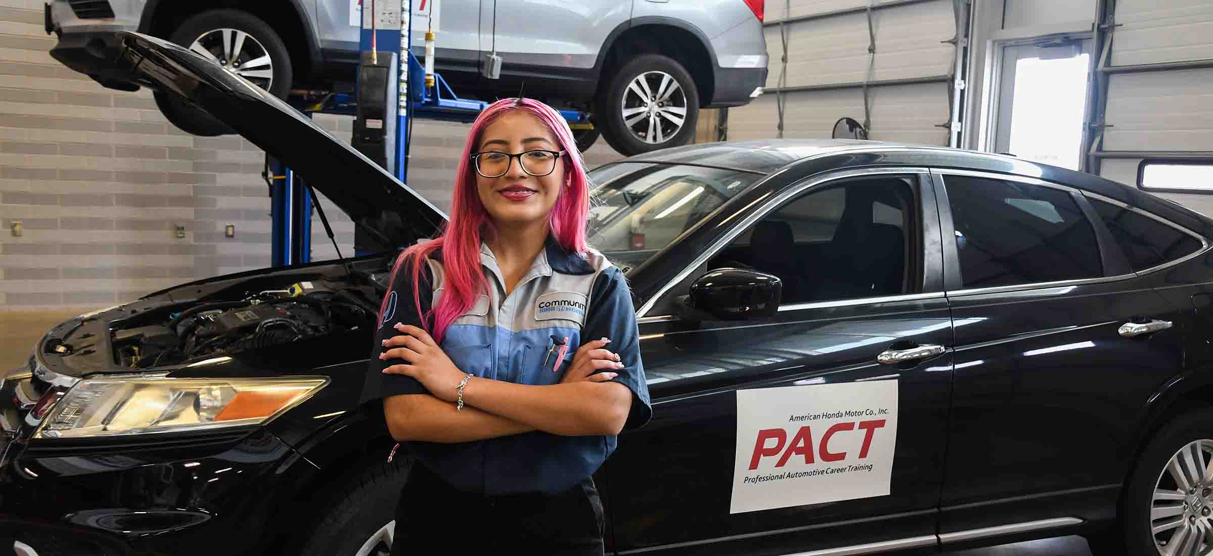 honda pact student, yisel, smiling for camera by a honda vehicle